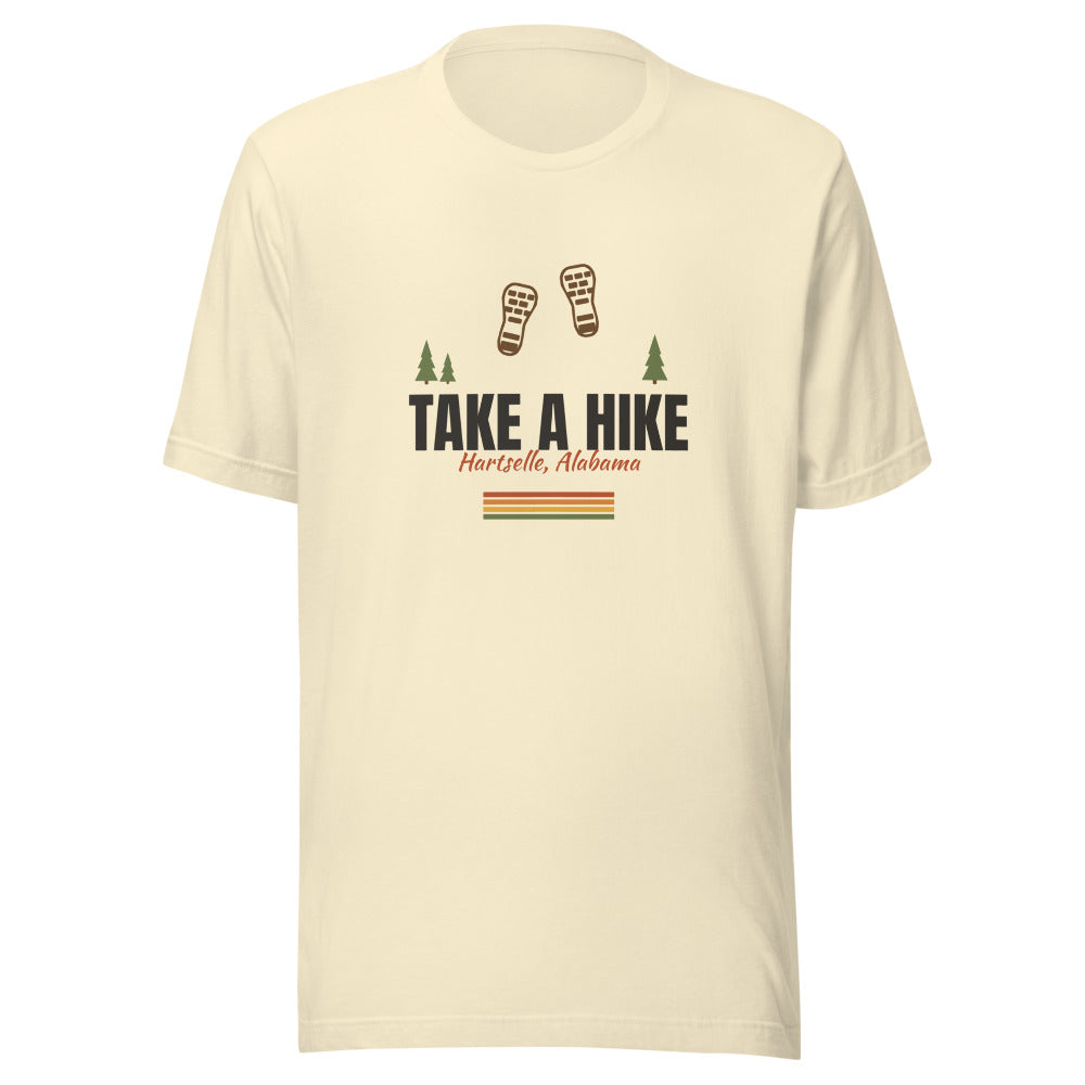 Take a Hike Tee — Natural, smaller boot prints with pine trees