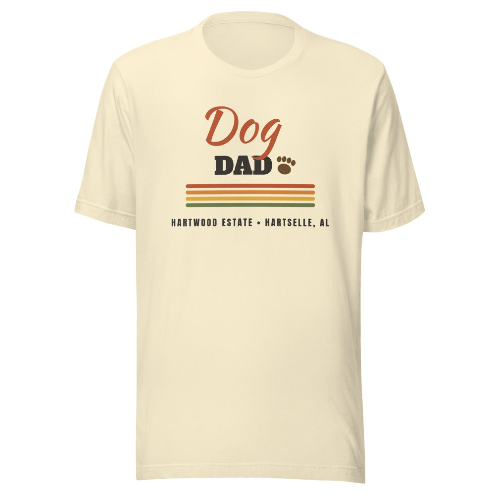 Dog Dad Tee — Natural, V1 lockup with paw beside DAD